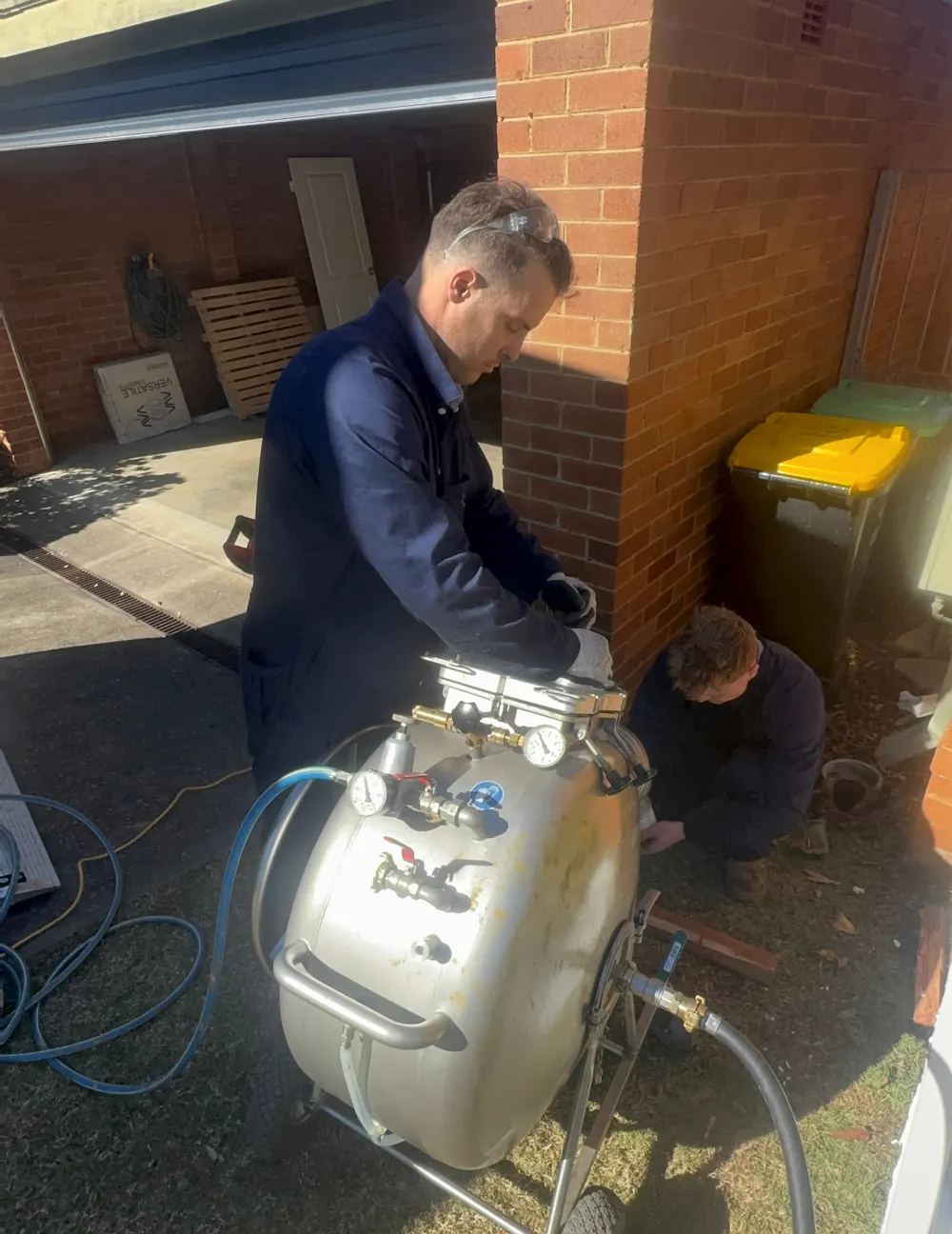 Prevail Plumbing operating pipe-relining inversion equipment during a Sydney drain repair