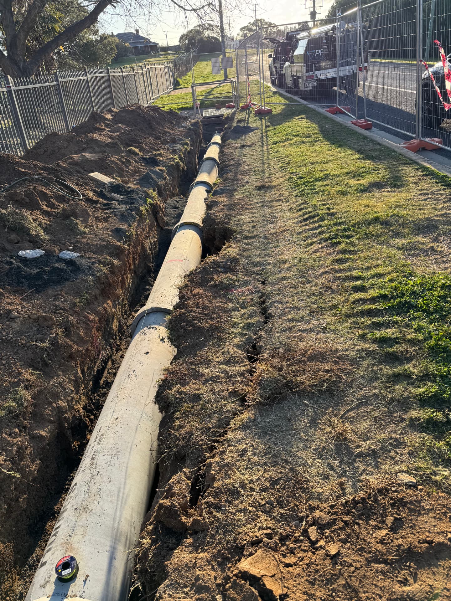 Long run of reinforced concrete stormwater pipe laid in an open trench