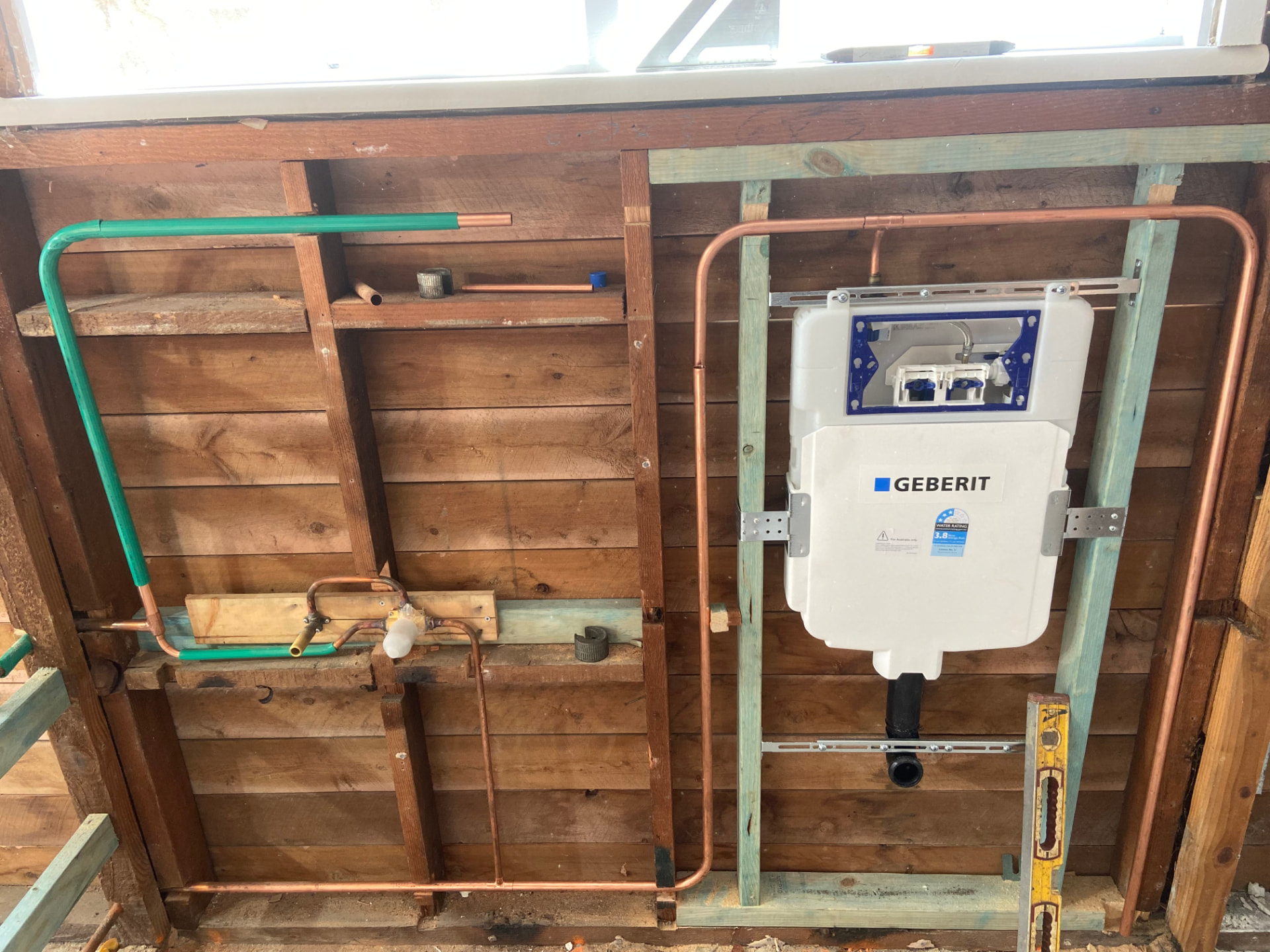 In-wall cistern frame with water and waste rough-in during a renovation