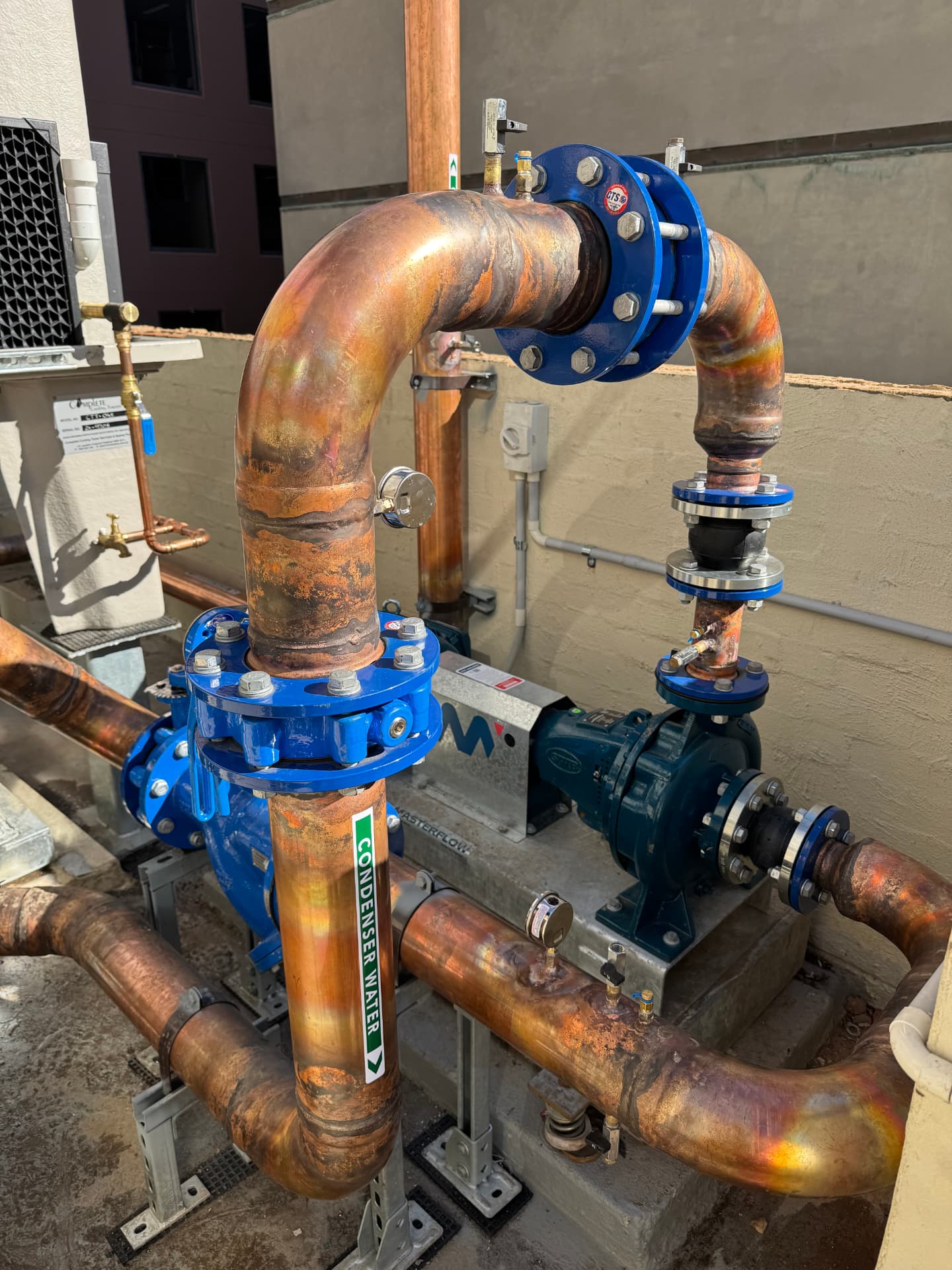 Brazed copper condenser water pipework and pumps installed by Prevail Plumbing