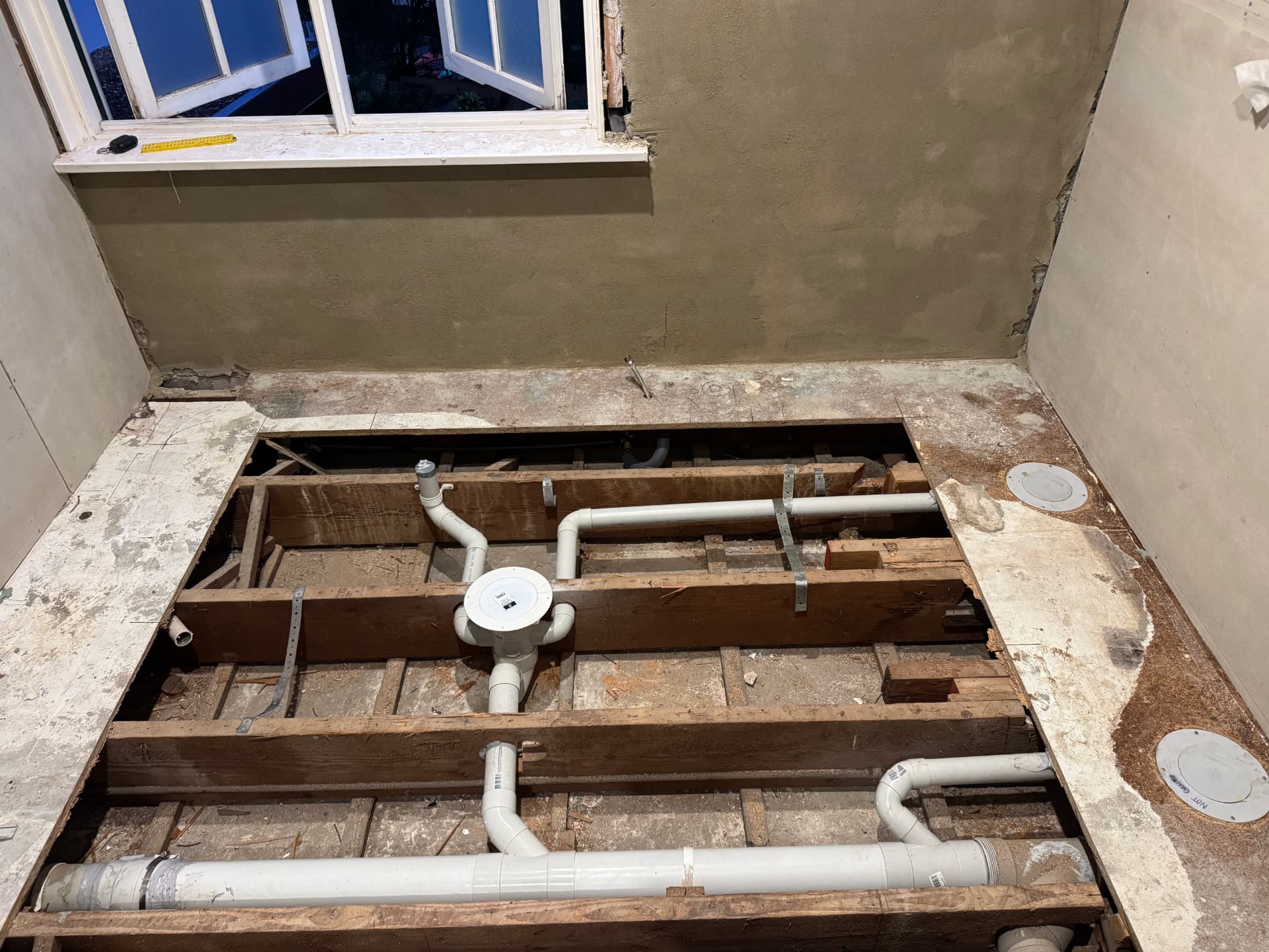Drainage and stackwork set out between floor joists before flooring is closed up